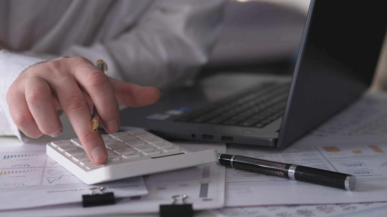 Statements and a calculator laid out together on a desk.