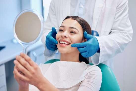 A dental surgery mid-appointment, lit and unhurried.